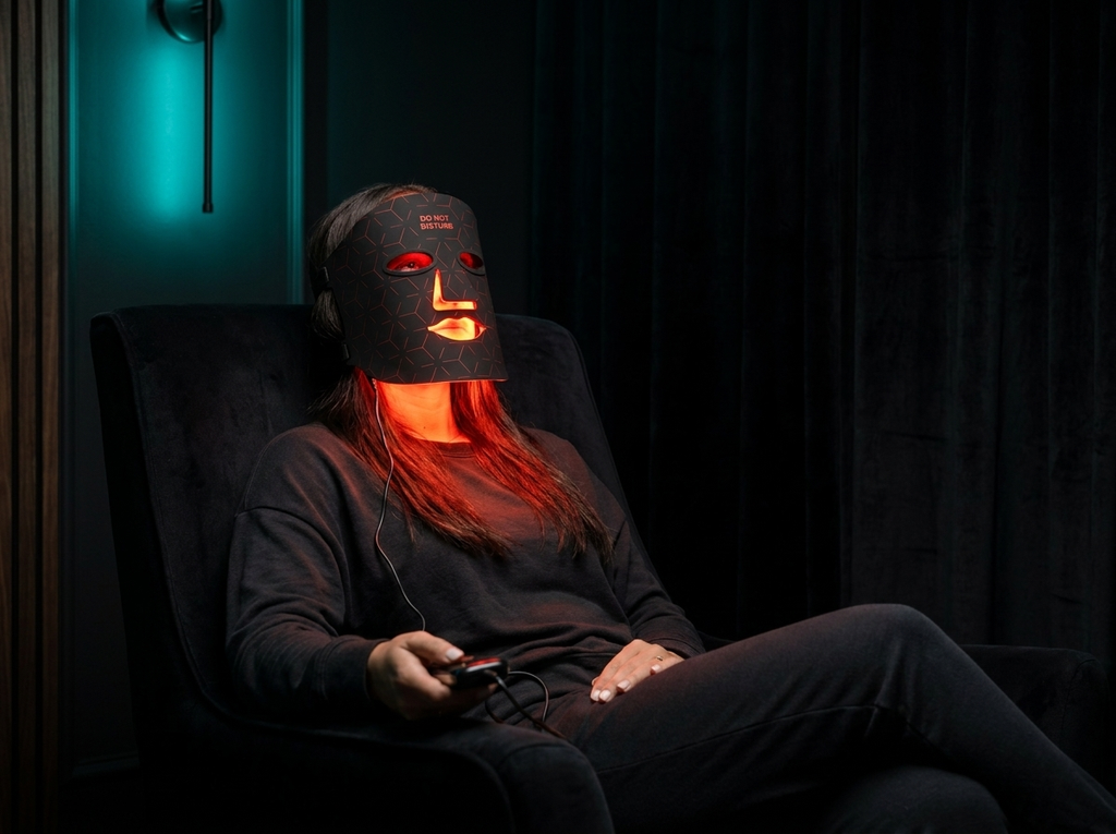 The Mask — Renew Red Light LED therapy mask worn in dark recovery room